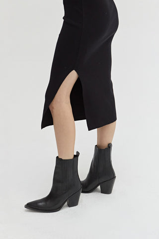 Close up of side slit on the one shoulder dress.