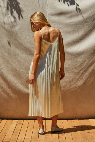 model wearing a pleated satin dress