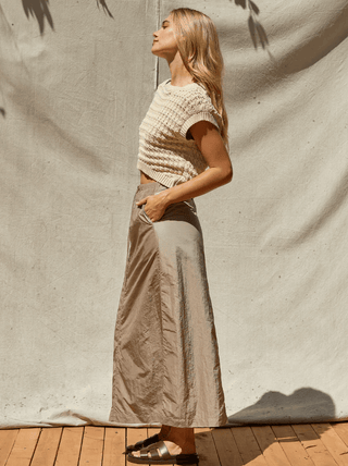 woman in a knit top and skirt that fits the 5 outfit rule