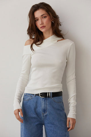 model wearing an asymmetrical knit top with jeans