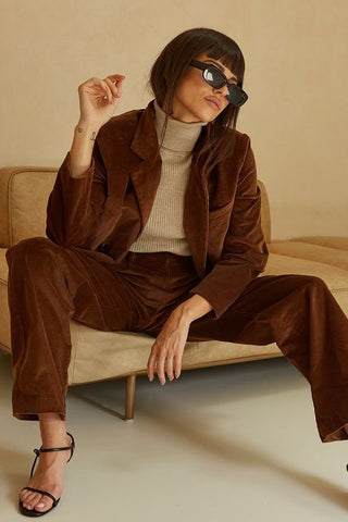 model wearing a brown co-ord blazer and pant set