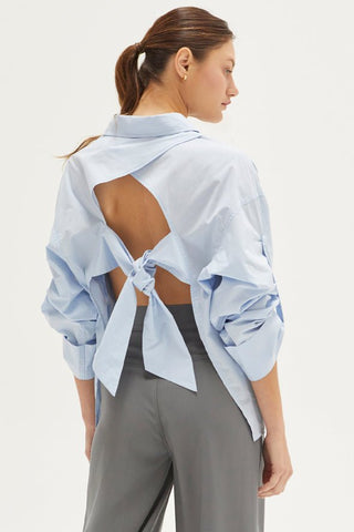 model wearing a cut-out tie button-up blouse