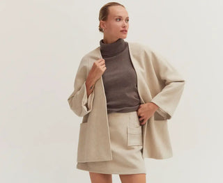 A woman dressed effortlessly in a 3-piece set by following outfit formulas