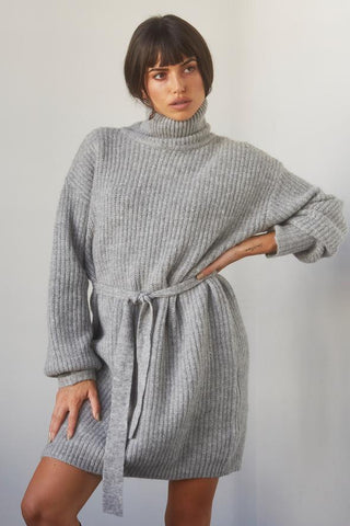 woman wearing a grey belted sweater dress