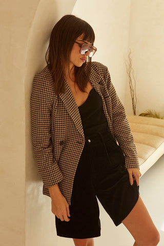 model wearing a houndstooth blazer