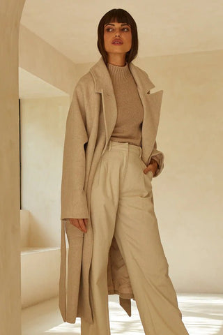 neutral monochromatic outfit with trench, blouse, and trousers