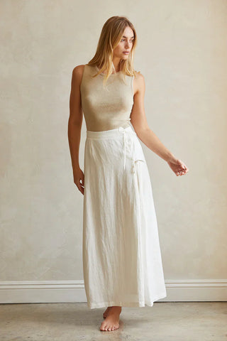 a model in a white linen maxi skirt
