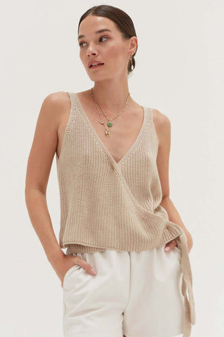 model wearing a neutral sleeveless wrap knit top