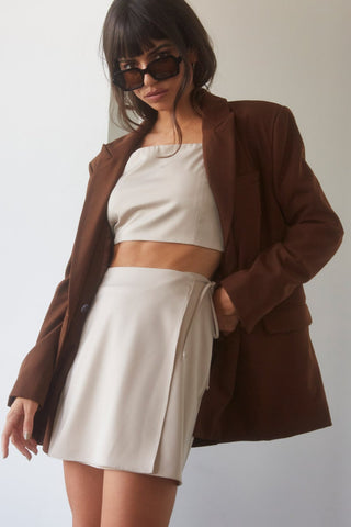 model wearing an oversized brown blazer