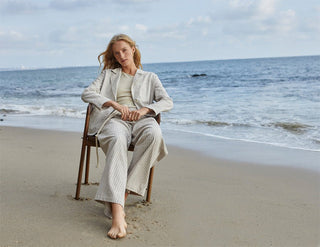 woman sitting on the beach in a suit