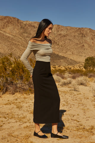 A woman wearing a tencel wool blend maxi skirt.