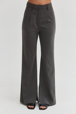 A woman wearing a wide-leg woven trousers.  
