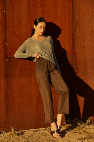 A woman wearing a straight leg cuffed hem trousers.