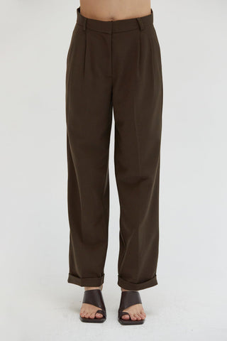 A woman wearing a straight leg cuffed hem trousers.