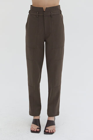 A woman wearing a high waisted seam detailed pants. 