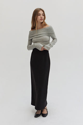 A woman wearing a tencel wool blend maxi skirt.
