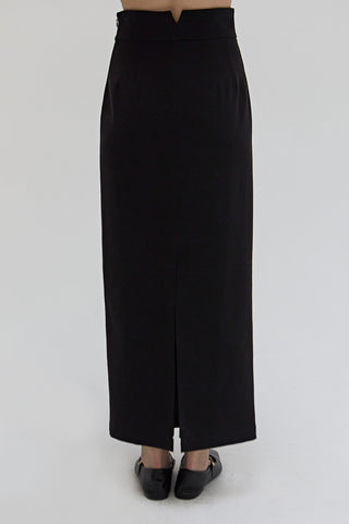 A woman wearing a tencel wool blend maxi skirt.