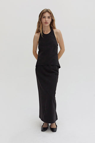 A woman wearing a tencel wool blend maxi skirt.