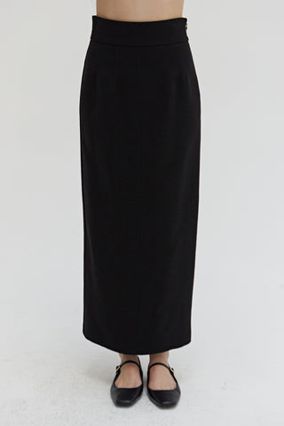 A woman wearing a tencel wool blend maxi skirt.