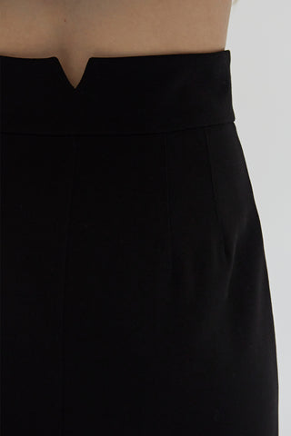 A woman wearing a tencel wool blend maxi skirt.