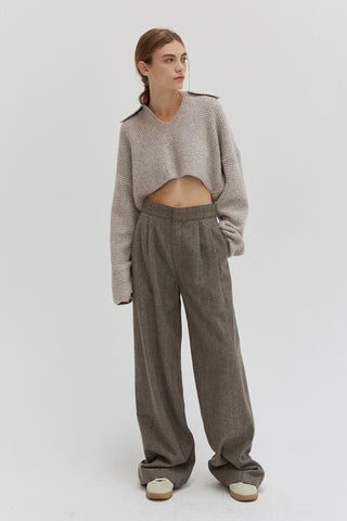 A woman wearing a waffle polo sweater. 