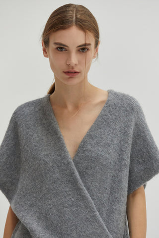 A model wearing a heather grey tunic sweater.