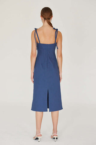 woman wearing denim dress showing off back of dress