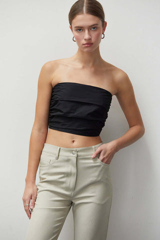 model wearing a black ruched tube top