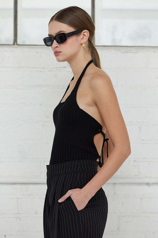 closeup of woman in black top standing sideways