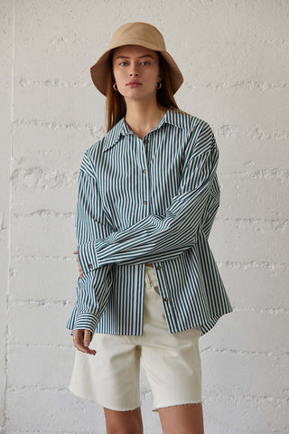 model wearing a green buttoned pinstripe shirt