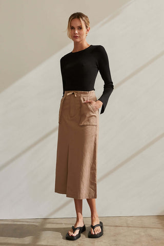 model wearing a khaki skirt and black top