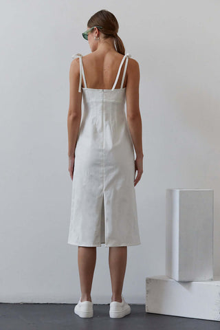 model showing off back of white denim dress