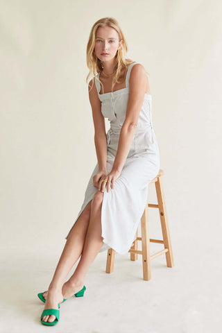 model wearing a striped dress with buttons