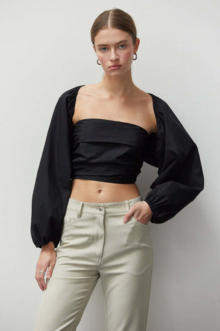 model wearing a two-piece bolero set in black