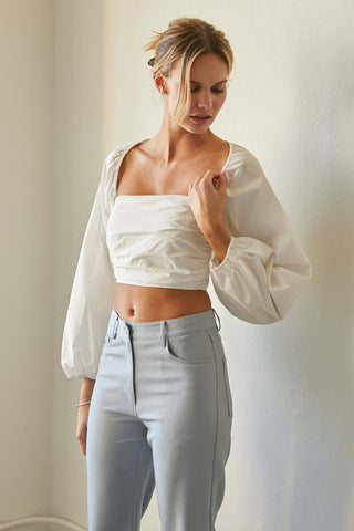 model wearing a two-piece white bolero set