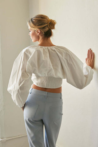 model wearing a white bolero sleeve top File 