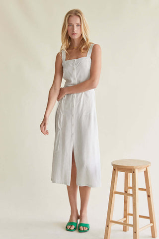 model wearing a white pinstriped midi dress