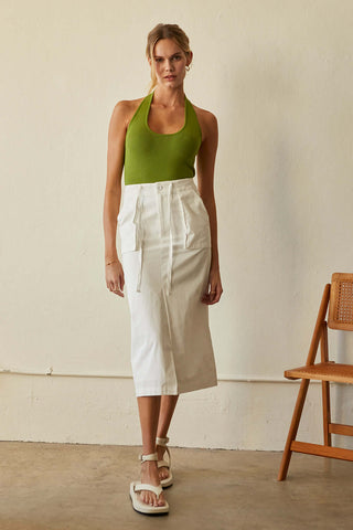 model wearing a white skirt and green top