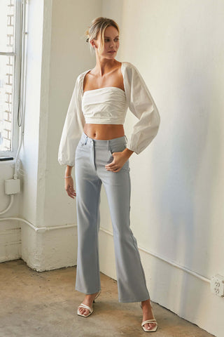 model wearing a white wide-sleeve crop top