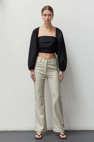 model wearing a wide-sleeve black top