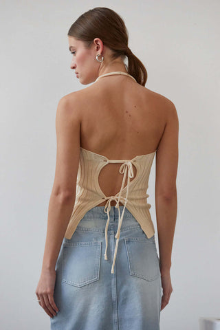 woman in cream top with back facing camera 