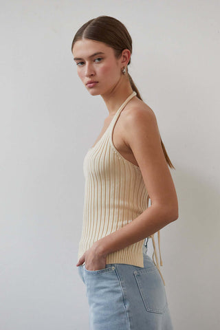 woman in cream top standing sideways