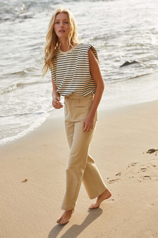 woman in striped top footprints in the sand