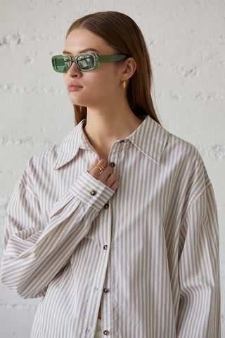 model wearing a women’s beige pinstripe shirt