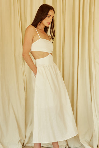 A woman wearing an ivory mixed media side cut out midi dress.