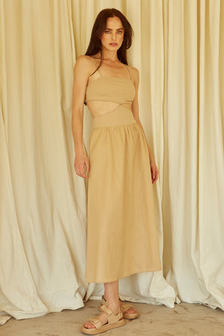 A woman wearing a taupe mixed media side cut out midi dress.