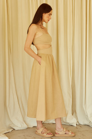 A woman wearing a taupe mixed media side cut out midi dress.