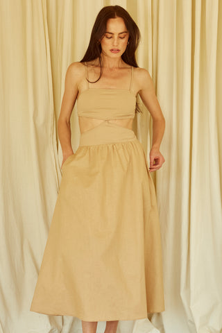 A woman wearing a taupe mixed media side cut out midi dress.