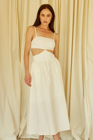 A woman wearing an ivory mixed media side cut out midi dress.