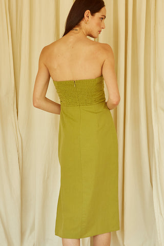 A woman wearing a fern ruched bodice straight line midi dress.